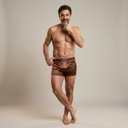 Man wearing brown Ares underwear against a plain background